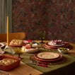 Table setting with olive runner, place settings, and taper candle.