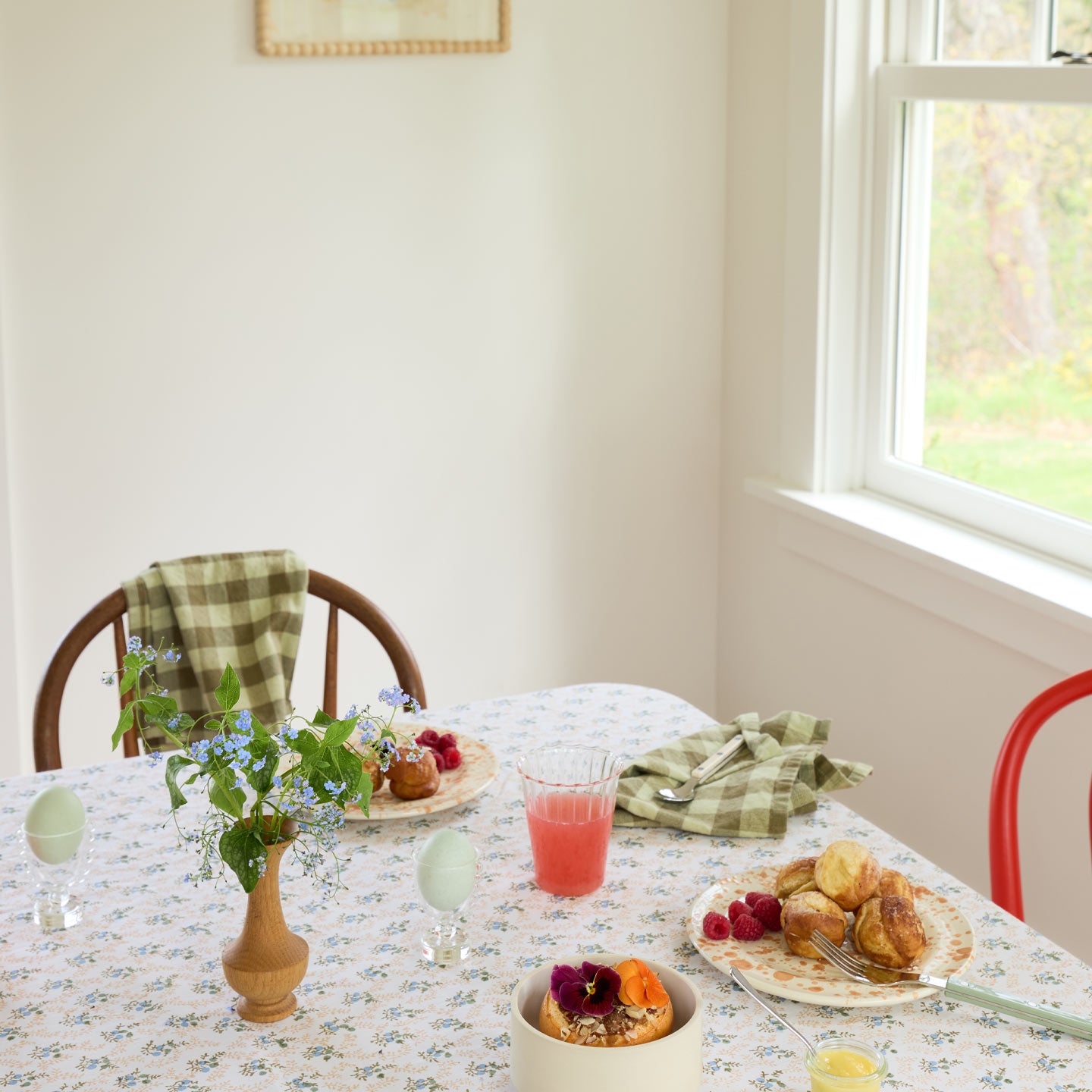 Spring tabletop setting with berries, pastries, eggs, and Essential Gingham Napkins in Olive.