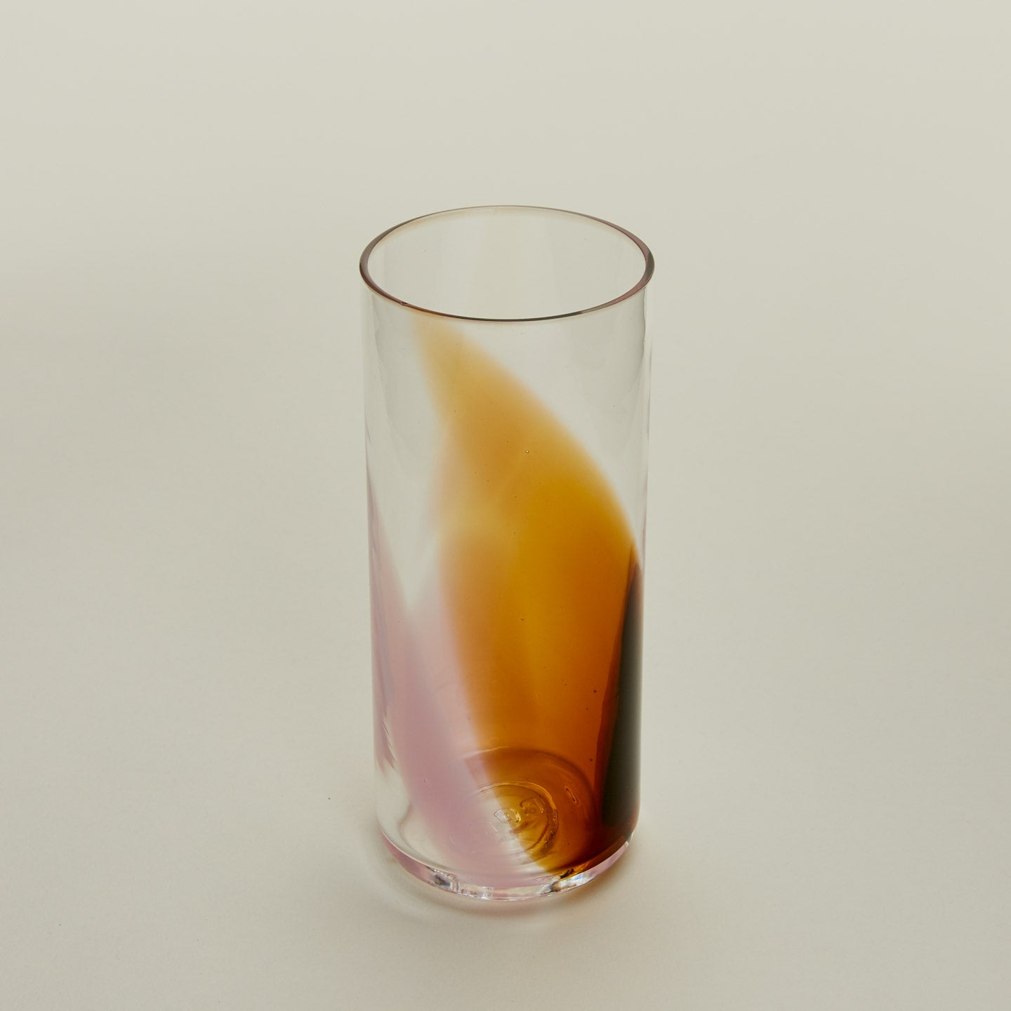 Close up of Blown Glass Highball in Blush and Amber.