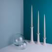 A pair of glass sphere vases and a trio of taper candle holders with taper candles. All in Sky tones.