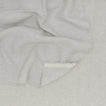 A Linen Washed Waffle Throw Blanket in natural.