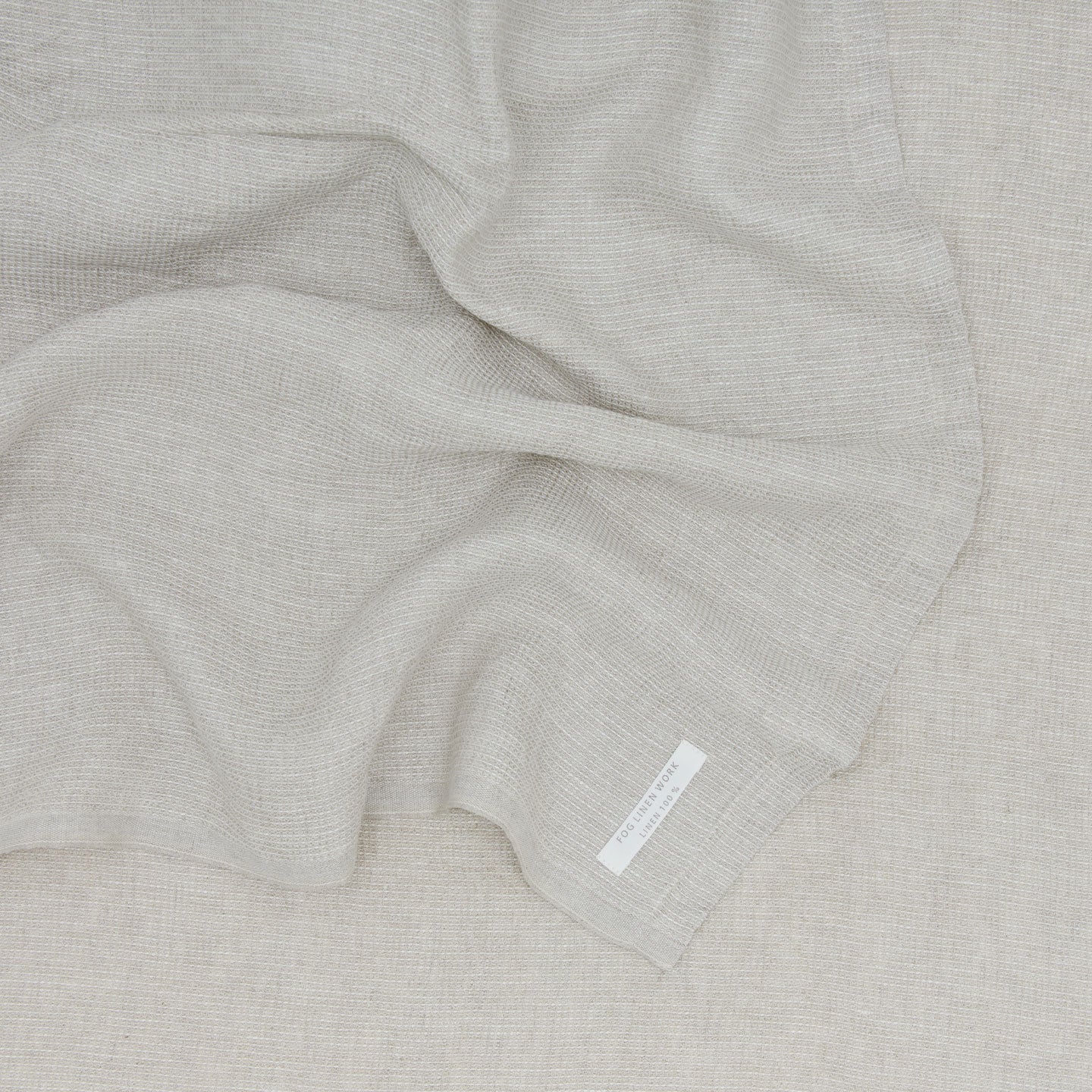 A Linen Washed Waffle Throw Blanket in natural.