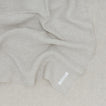 A Linen Washed Waffle Throw Blanket in natural.