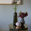Essential Ceramic Vase in Olive with flowers and other vases.