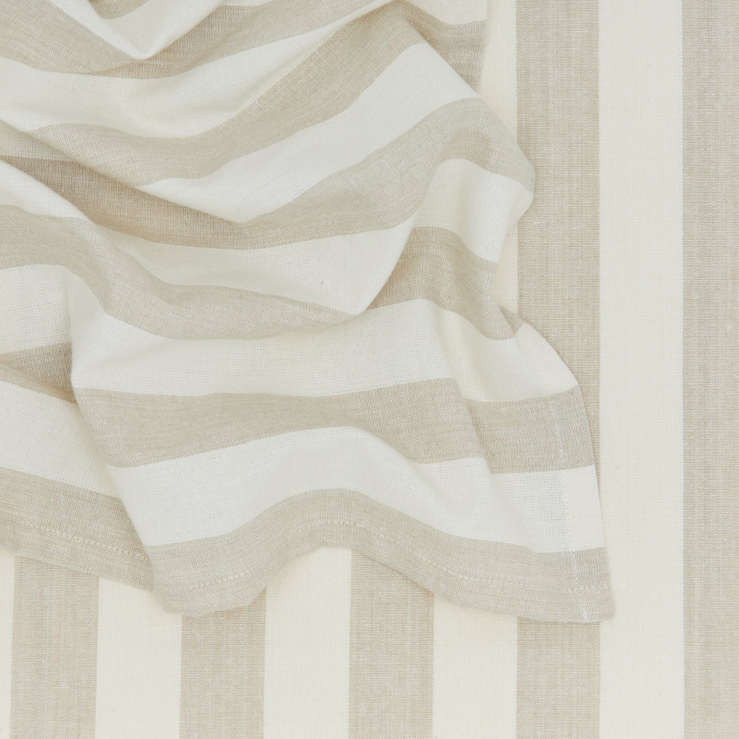 Close up of Essential Striped Dinner Napkin in Ivory and Flax.