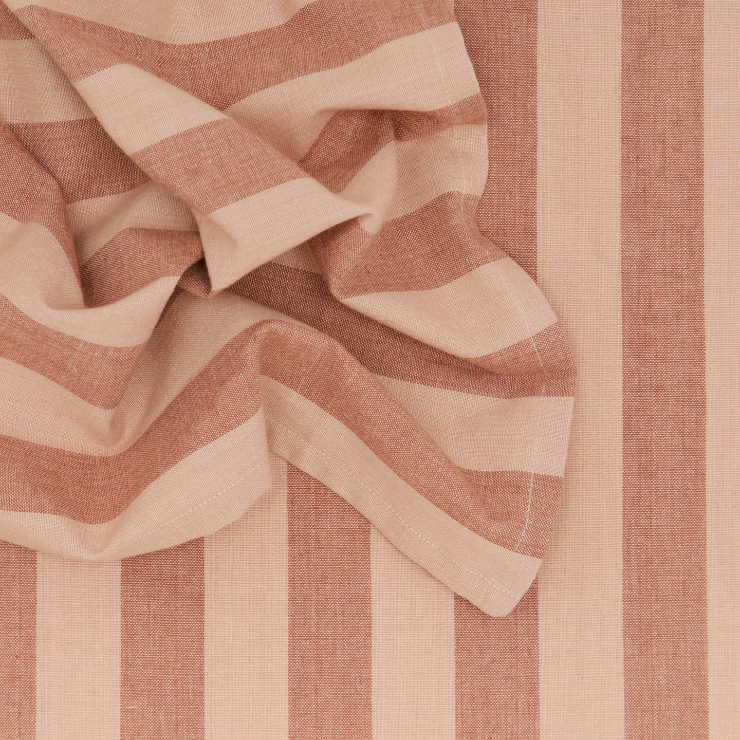 Close up of Essential Striped Dinner Napkin in Blush and Terracotta.