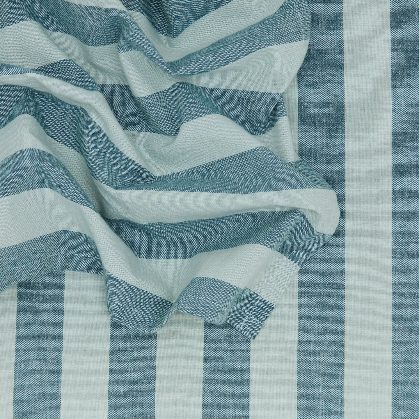 Close up of Essential Striped Dinner Napkin in Sky and Peacock.