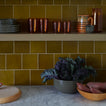 Kitchen shelves with bowls and produce and Essential Glassware in Terracotta and Essential Plates in Olive.