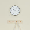 Graphic wall clock with coat hooks