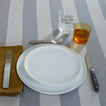 Placesetting on Essential Striped Tablecloth in Light Grey and Dark Grey with bronze napkin.
