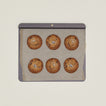 Baking tray with parchment paper and cookies