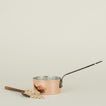 Copper saucepan with scoop and oats