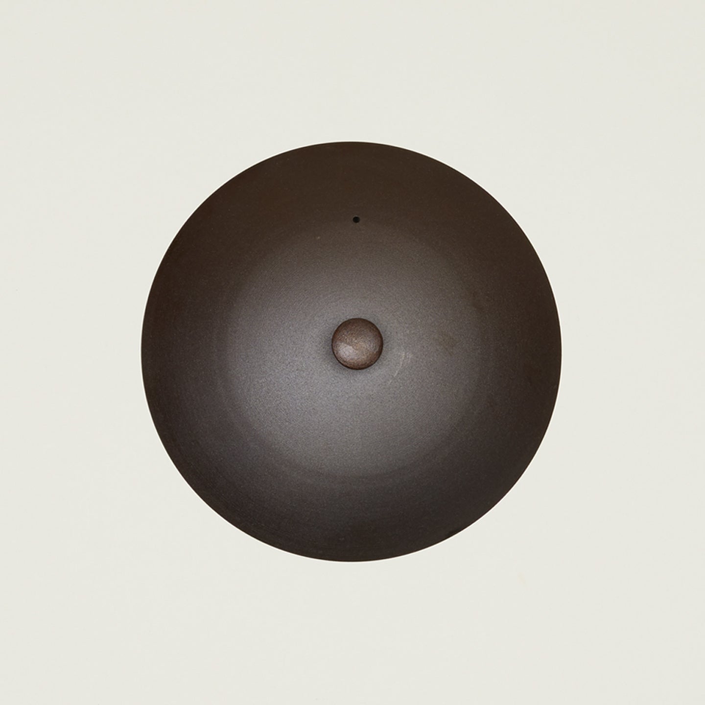 Overhead view of spun iron wok lid