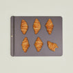 Large spun iron baking tray with croissants