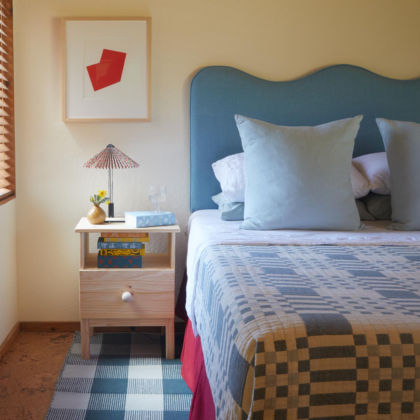Bedroom with a bed, nightstand, and wall art