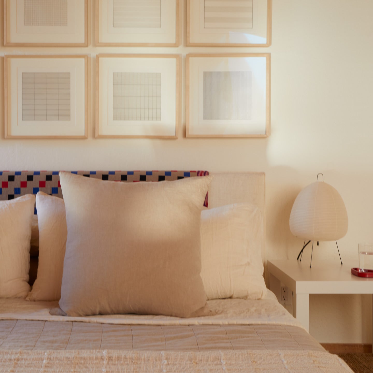 Neatly made bed with flax pillows in a bedroom setting.
