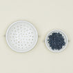 Overhead view of large and small colander with blueberries