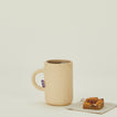 Al Centro Ceramica cylinder mug with tea and pastry