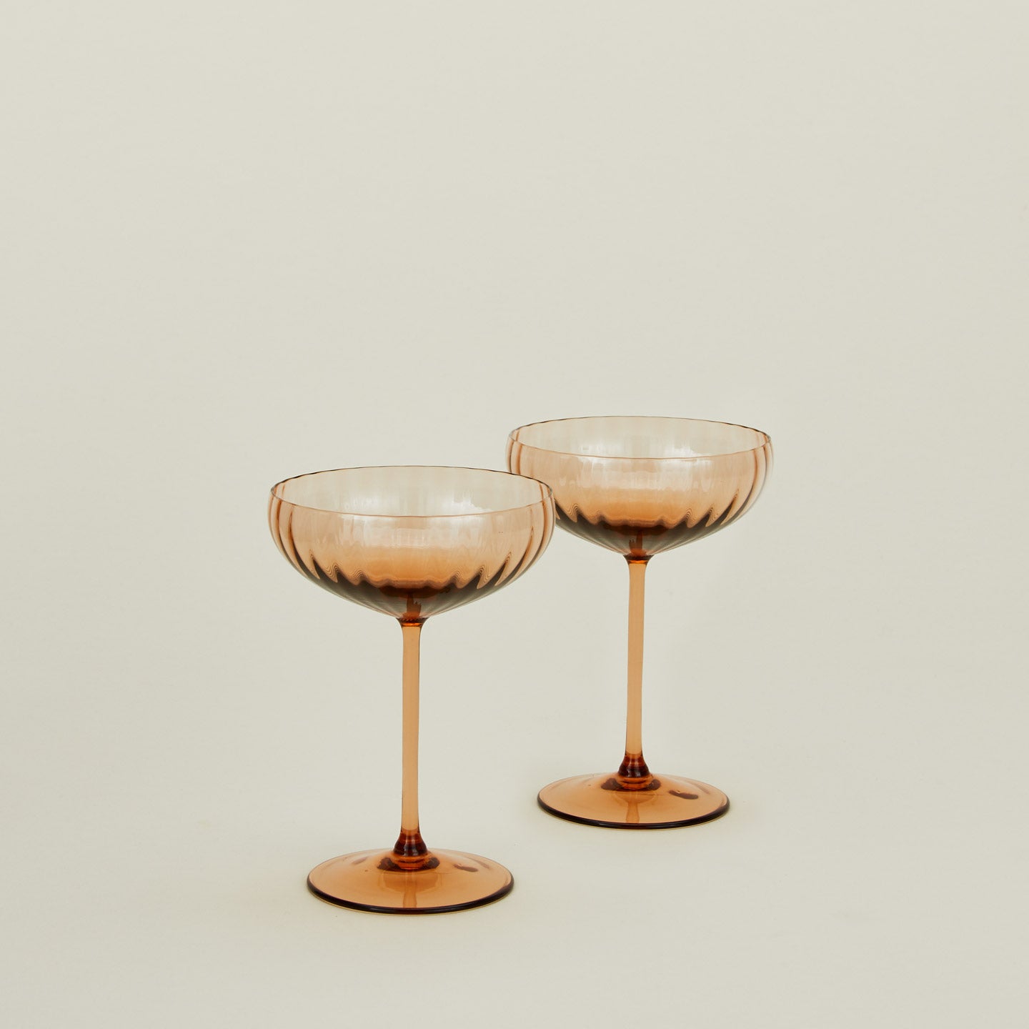 Set of two ribbed brown coupe glasses.