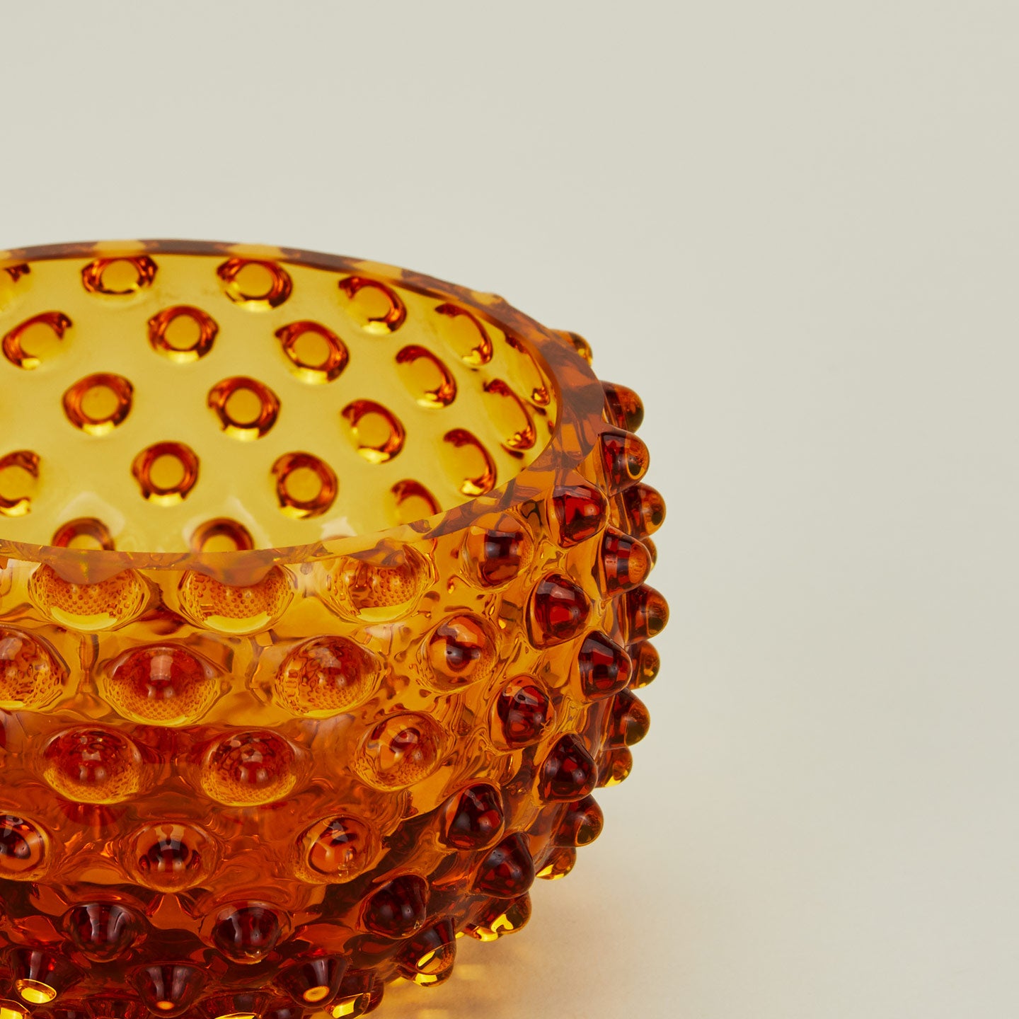 Close up of glass hobnail amber tapas bowl.