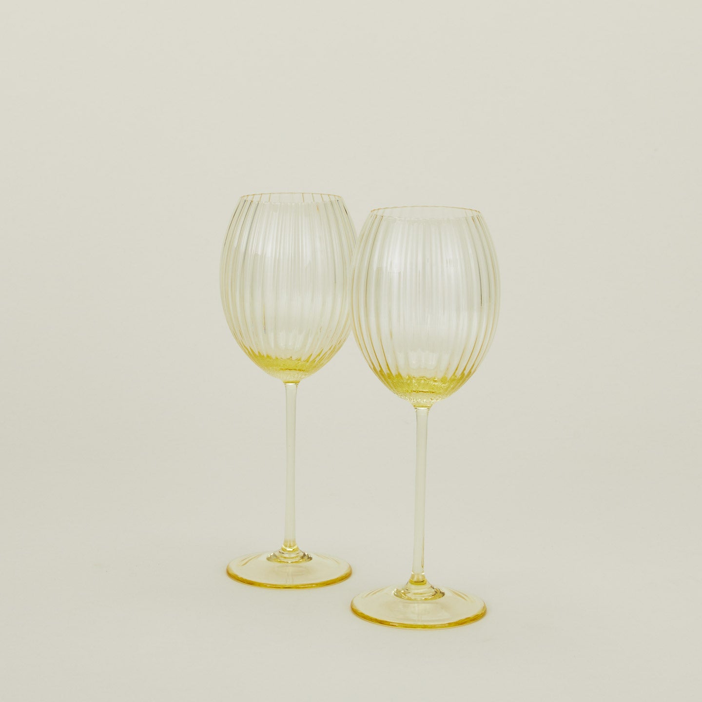 Set of two ribbed amber wine glasses.