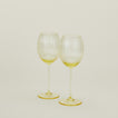 Set of two ribbed amber wine glasses.