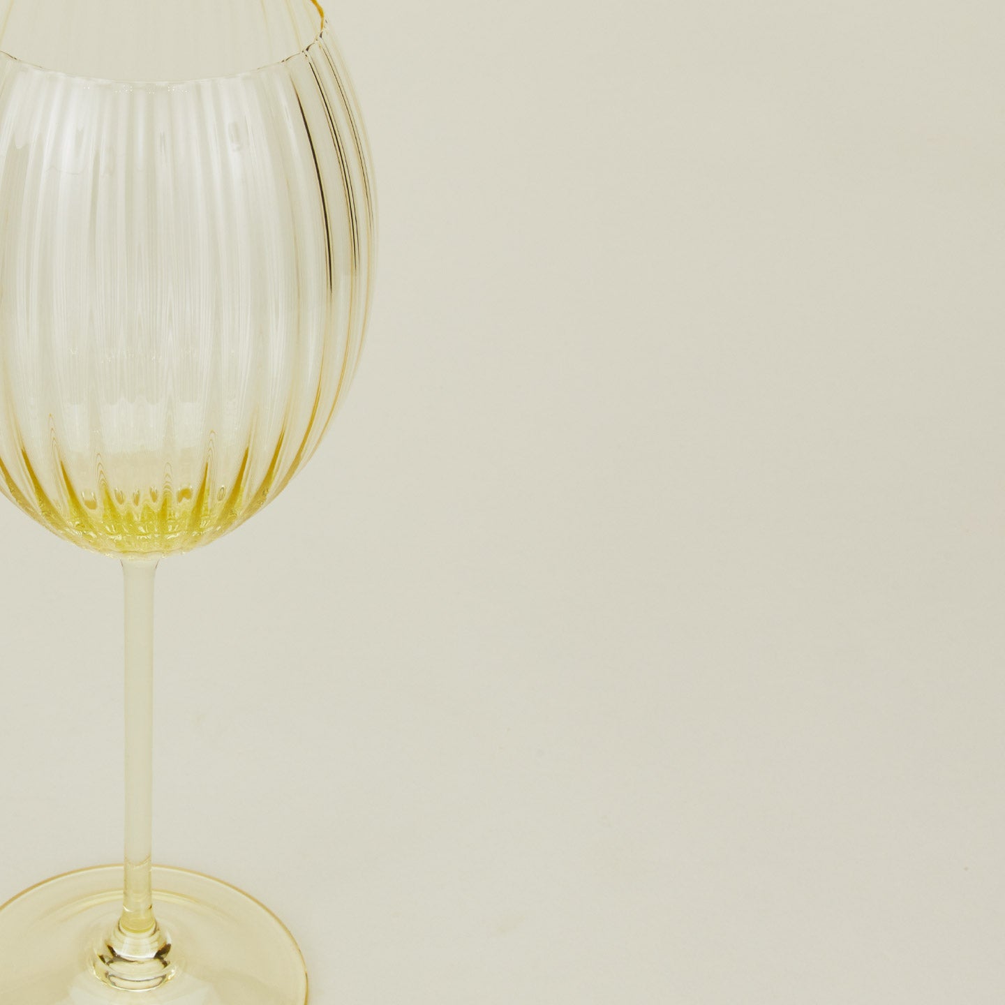 Close up of ribbed amber wine glass.