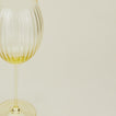 Close up of ribbed amber wine glass.