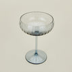 Three-quarter angle of ribbed blue coupe glass.