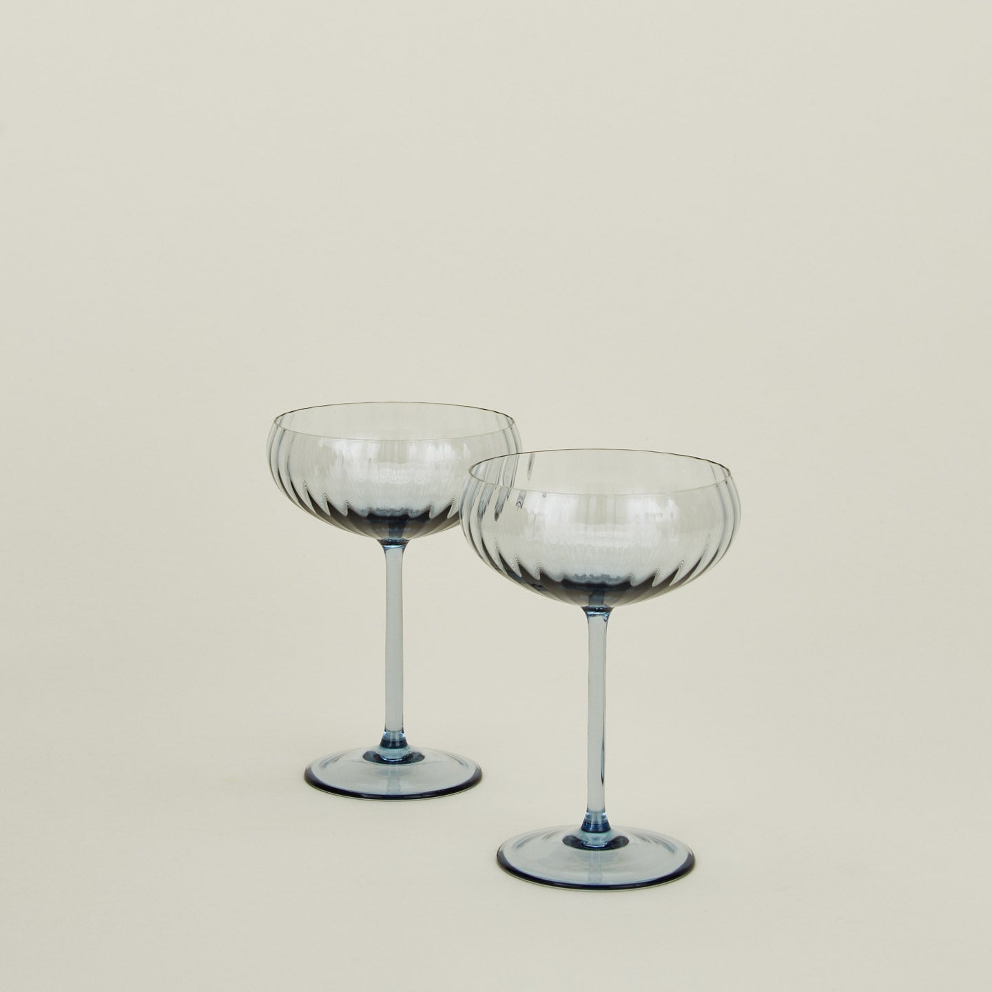 Set of two ribbed blue coupe glasses.