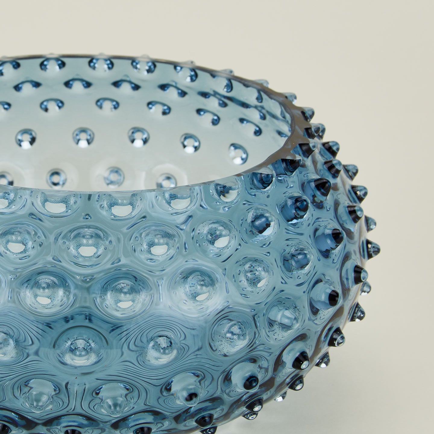 Close up of glass hobnail blue serving bowl.