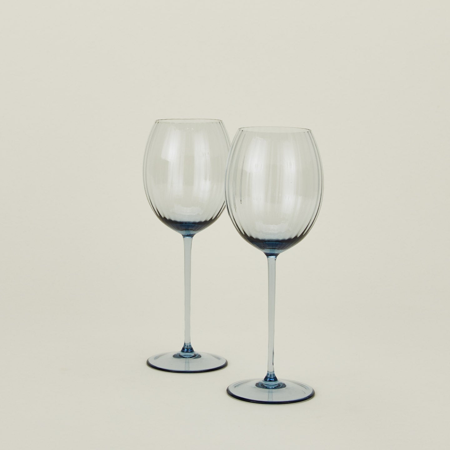 Set of two ribbed blue wine glasses.