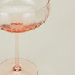 Close up of ribbed blush coupe glass.