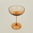 Three-quarter angle of ribbed brown coupe glass.