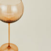 Close up of ribbed brown wine glass.