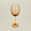 Three-quarter angle of ribbed brown wine glass.