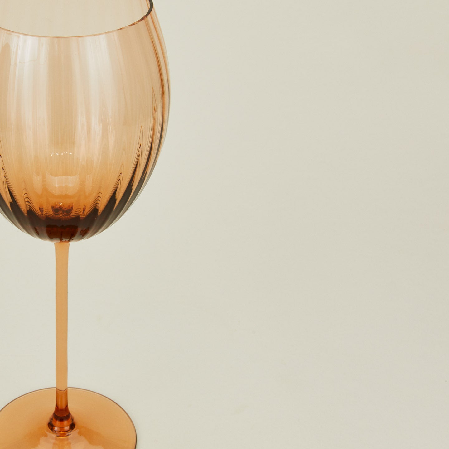 Close up of ribbed brown wine glass.