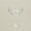 Three-quarter angle of ribbed clear coupe glass.