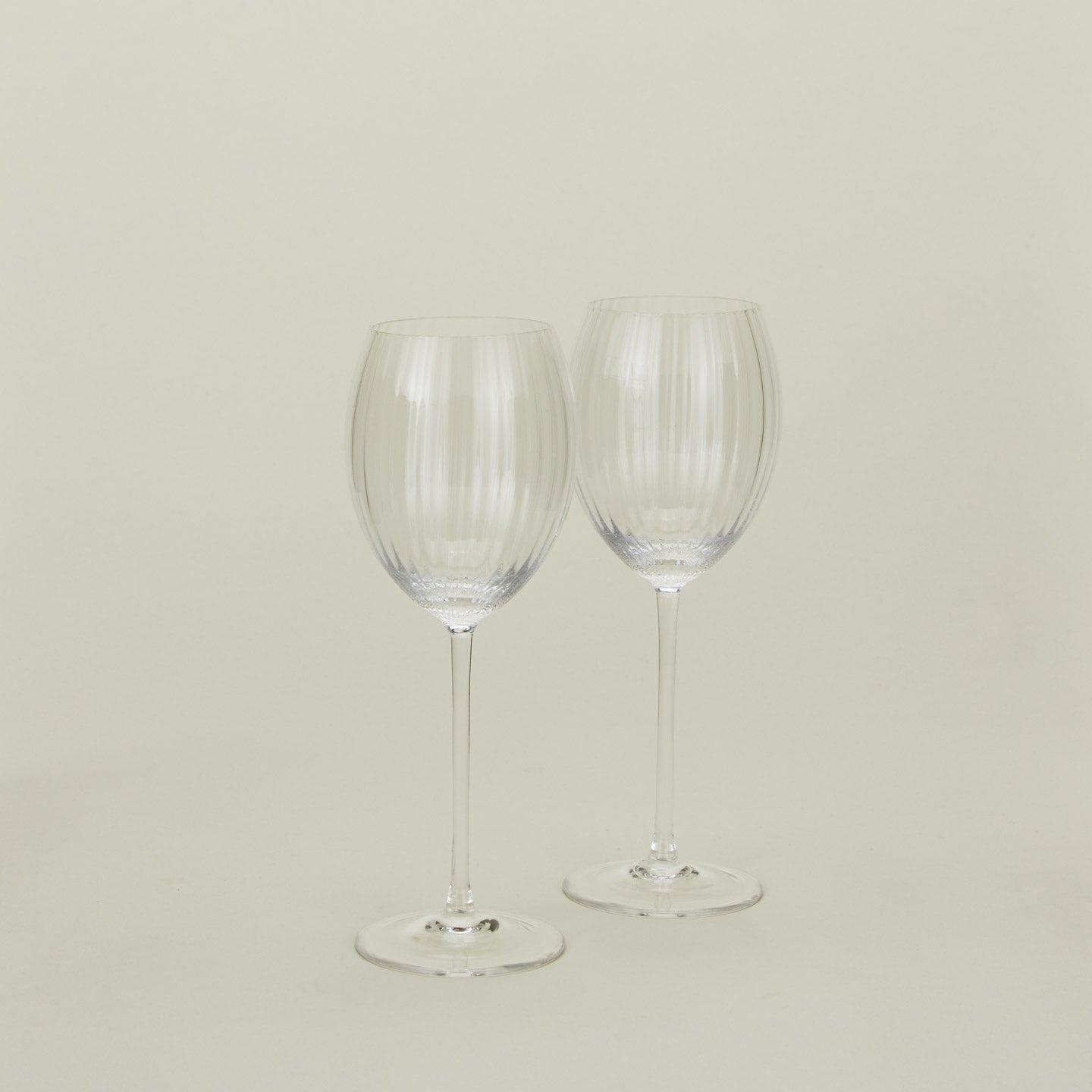 Set of two ribbed clear wine glasses.