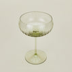 Three-quarter angle of ribbed olive coupe glass.