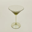 Three-quarter angle of ribbed olive martini glass.