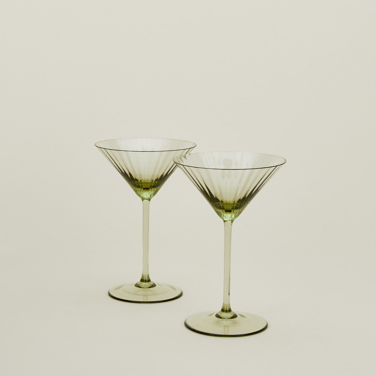 Set of two ribbed olive martini glasses.
