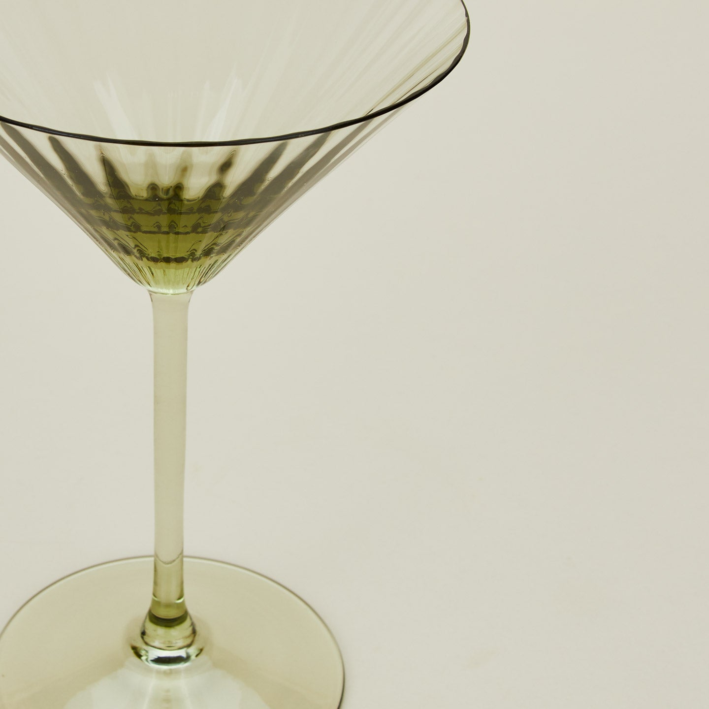 Close up of ribbed olive martini glass.