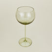 Three-quarter angle of ribbed olive wine glass.