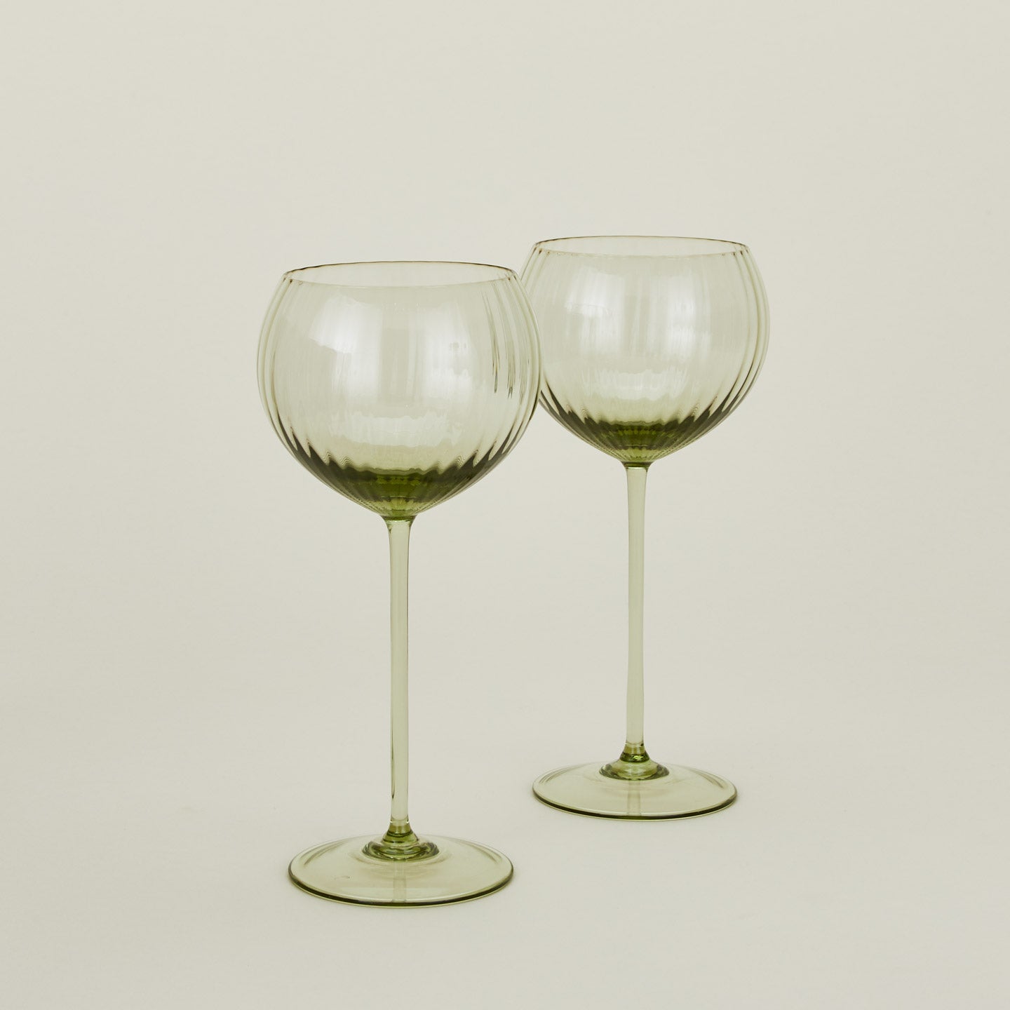 Set of two ribbed olive wine glasses.