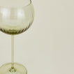 Close up of ribbed olive wine glass.