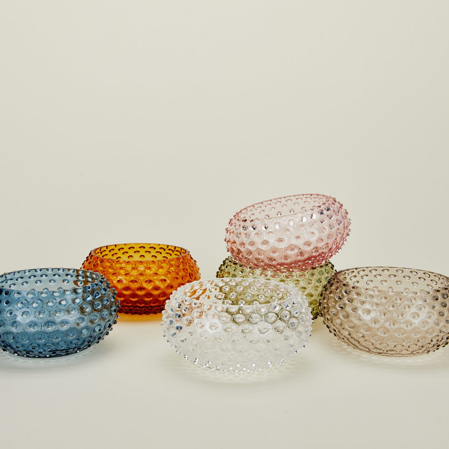 Glass hobnail serving bowls in a variety of colors.