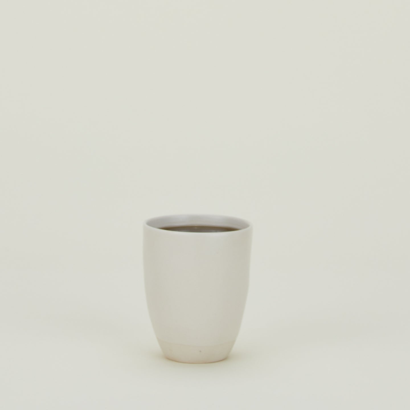 Atelier Mug, filled with coffee.