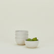 Four Atelier Small Bowls, with limes.