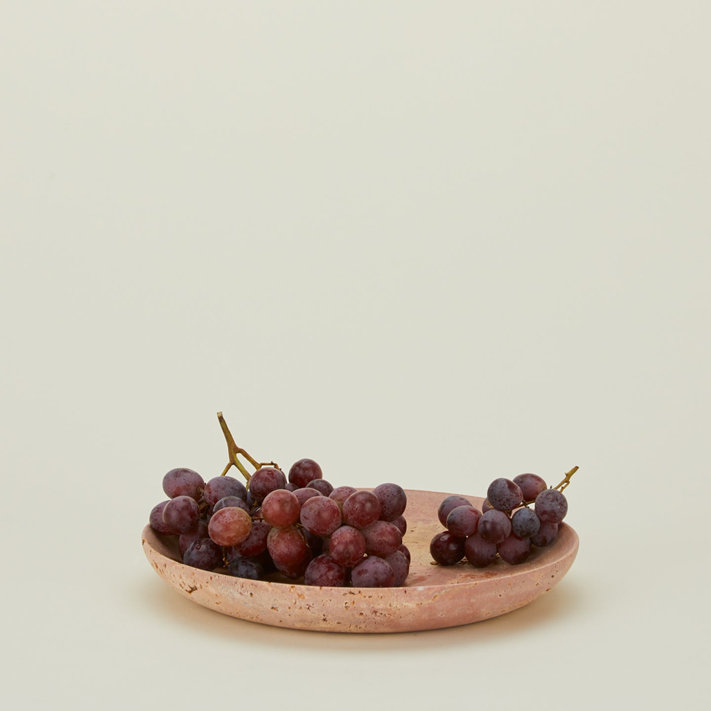 Red travertine tray with grapes